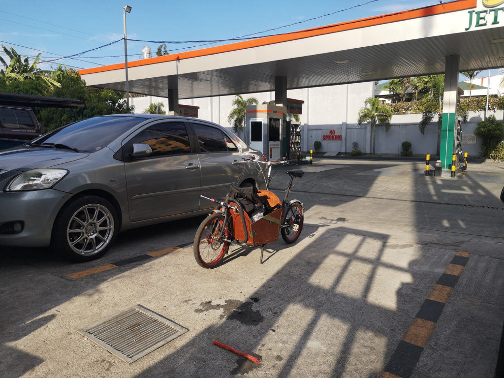 Compact Utility Bike (CUB) parked beside a car