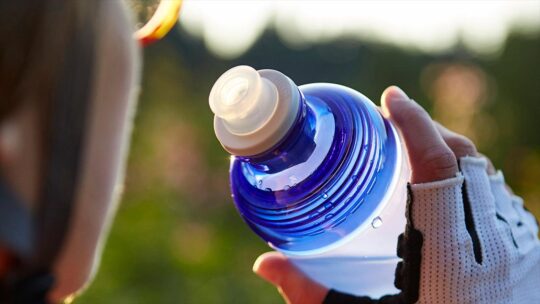 cyclist drinking from water bottle